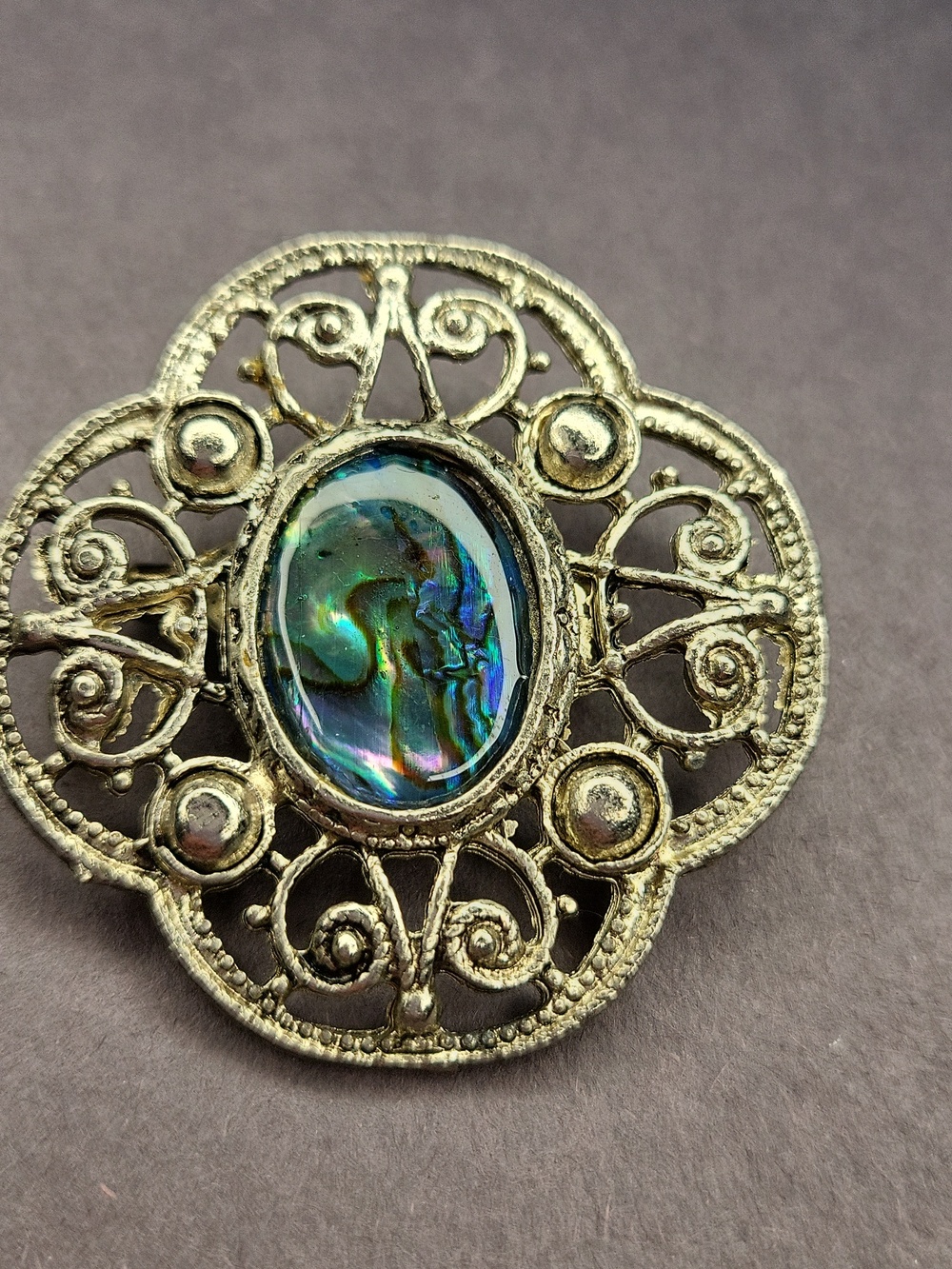 Elegant Silver Filigree Brooch with Iridescent Stone